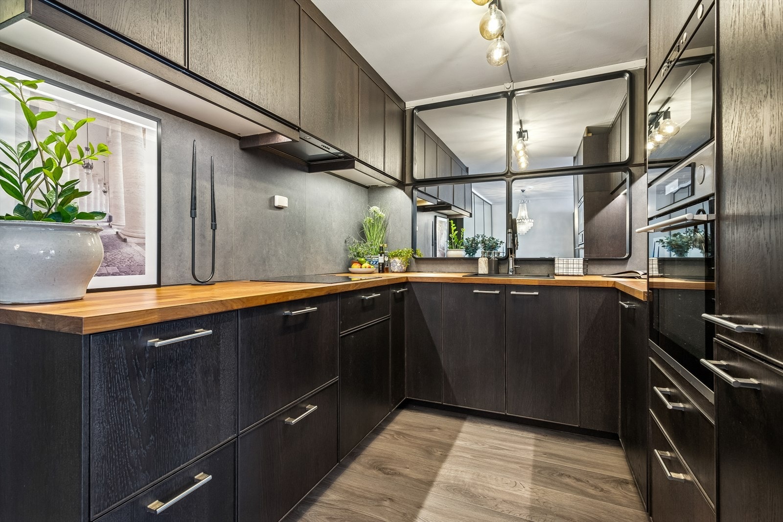 Innredningen har glatte, mørke fronter og en solid benkeplate i heltre. Galleribilde