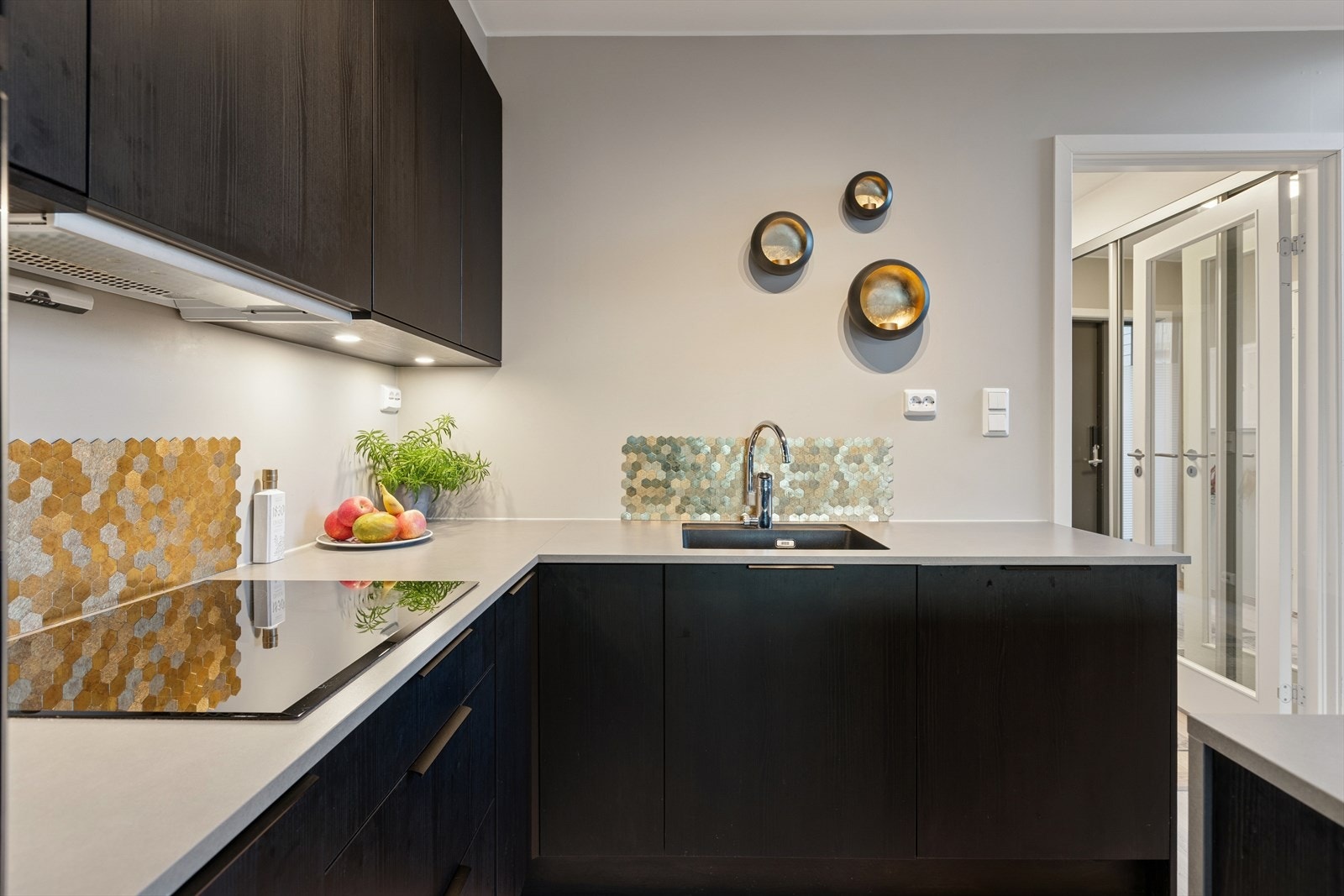 Moderne innredning med glatte fronter og benkeplate i laminat med oppvaskkum og blandebatteri. Galleribilde