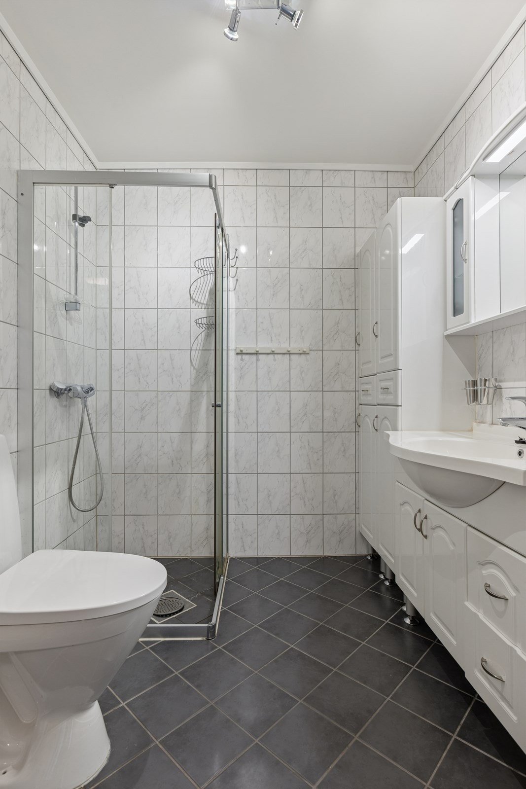 Badet er praktisk innredet med opplegg for både vaskemaskin og tørketrommel. Galleribilde