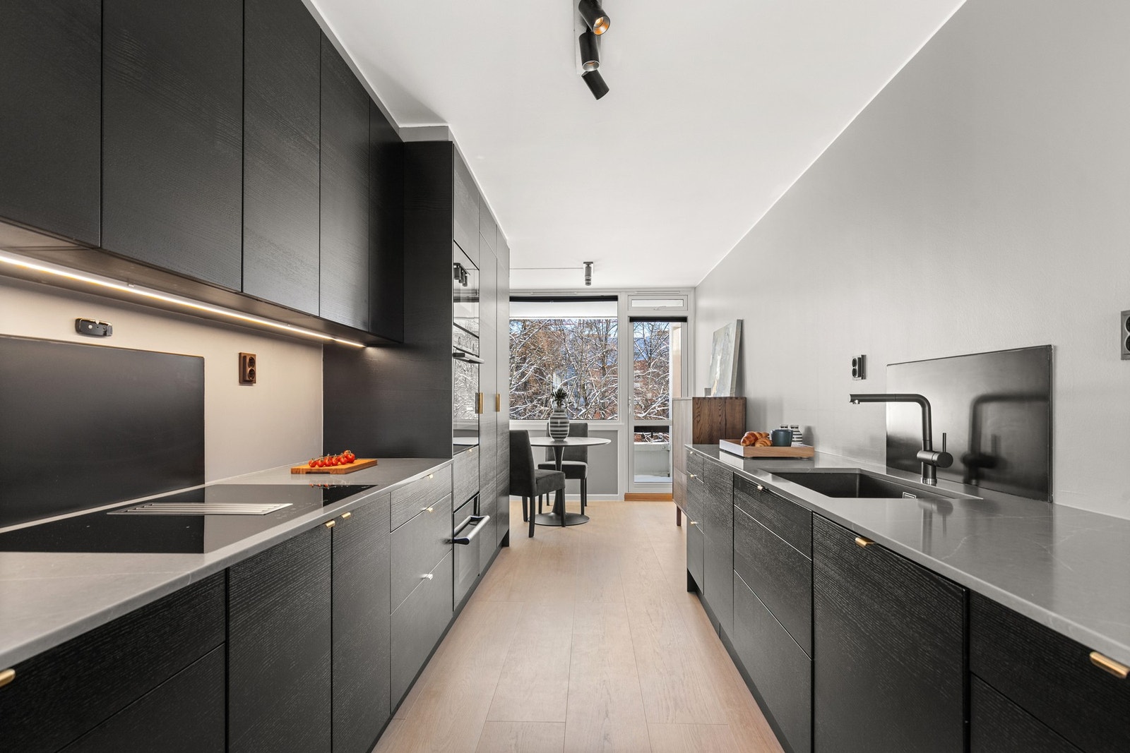 Kjøkkenet er fra Epoq i sort ask med trestruktur og har en praktisk tosidig løsning med godt med oppbevaringsplass. Galleribilde