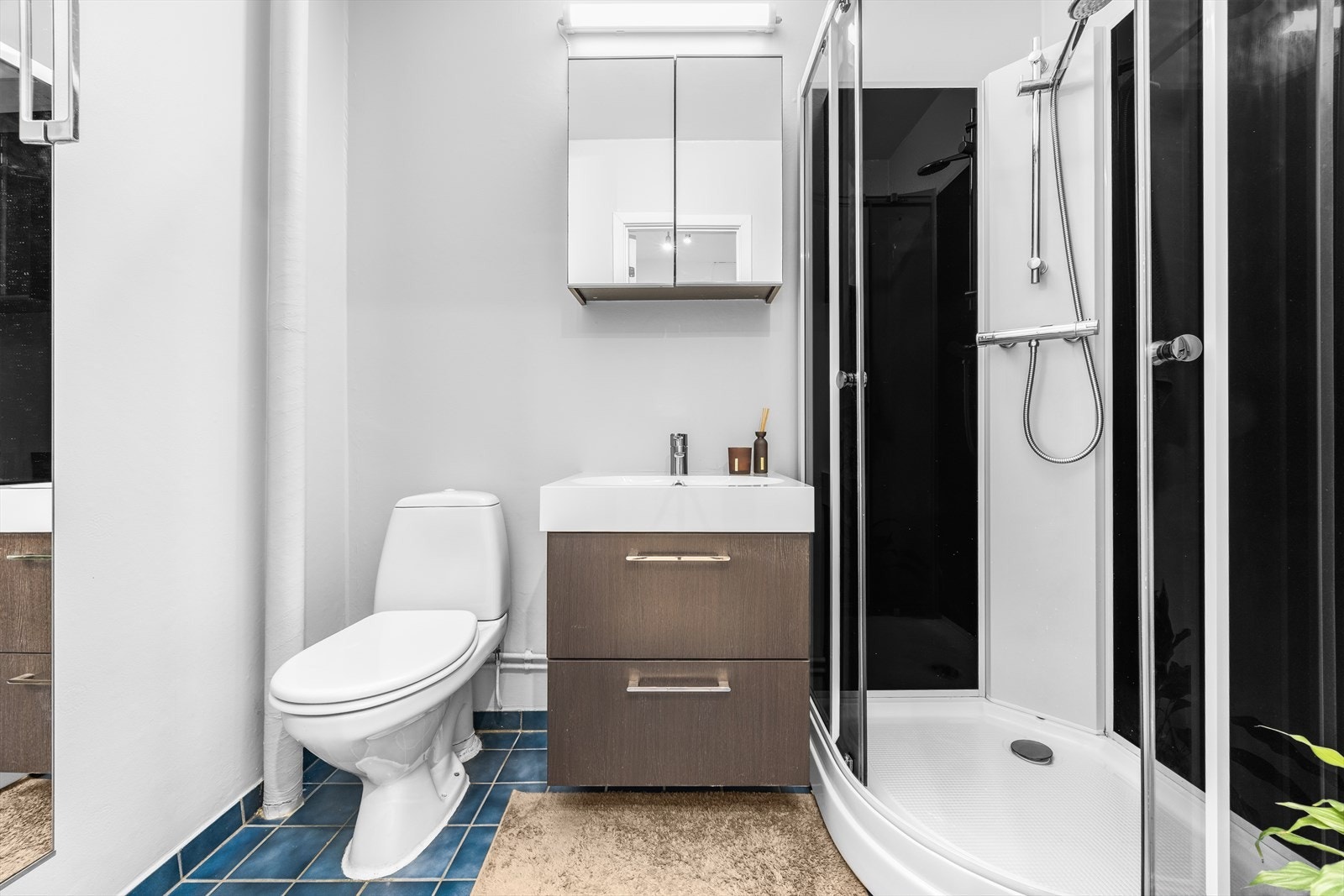 Baderommet har hovedkonstruksjoner fra byggeår og er innredet med servantskap med ett-greps blandebatteri, høyskap, speilskap, gulvstående toalett og dusjkabinett. Galleribilde