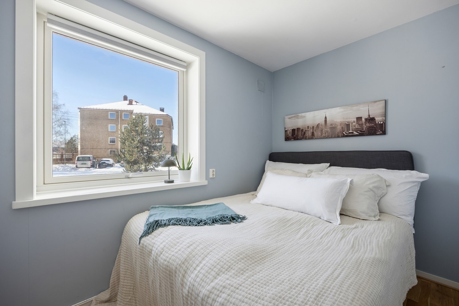 Boligen har et lyst og innbydende soverom med en rolig atmosfære. Rommet har en stor vindusflate som slipper inn rikelig med dagslys, og de lyse veggene og det gjennomgående pene gulvet gir et moderne og behagelig uttrykk. Galleribilde