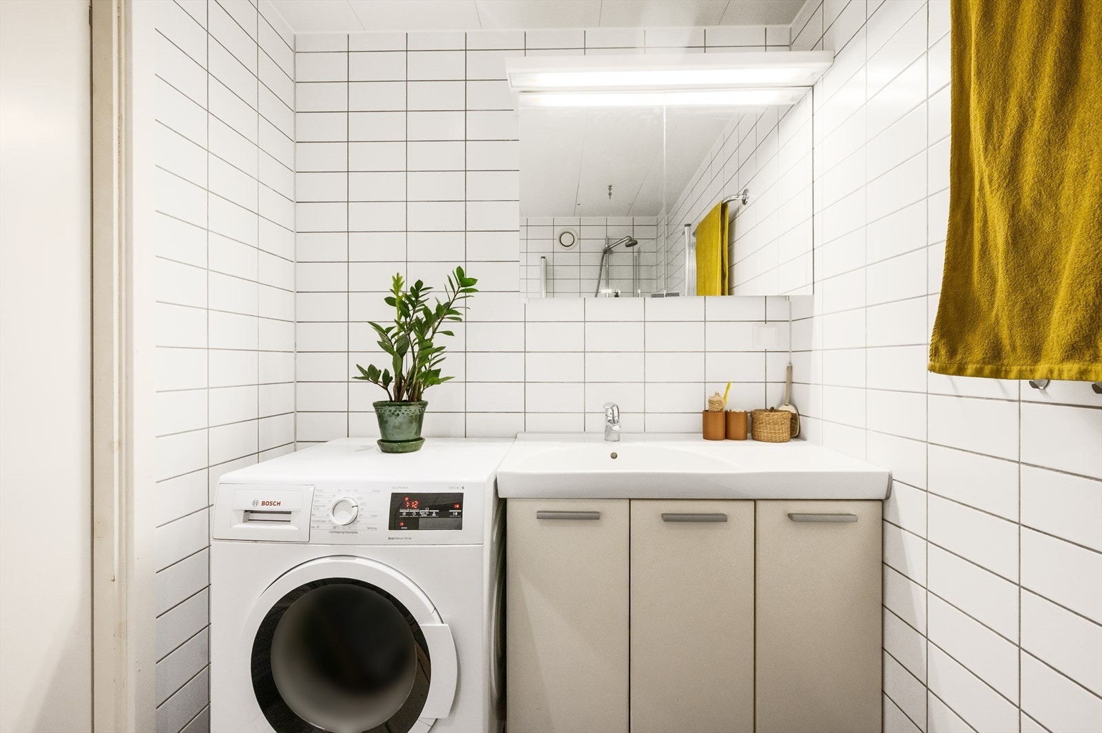 Innredningen består av servantskap, speilskap, vegghengt toalett og dusjhjørne med svingdører i glass. Galleribilde