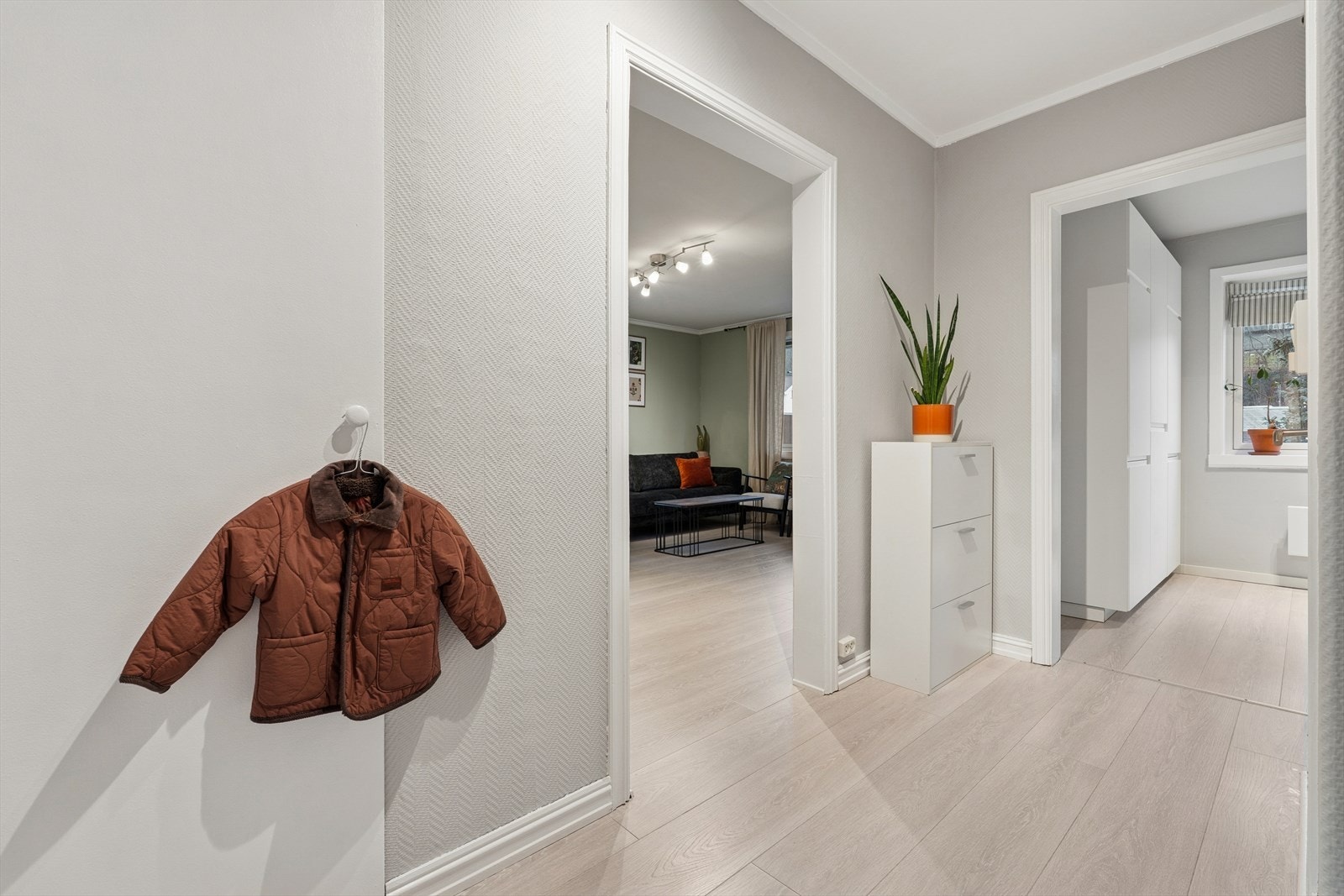 Lys og delikat entré med et innebygget skap som man kan henge fra seg yttertøy og annet man ønsker å rydde vekk. I gangen er det callinganlegg med kamera og automatisk døråpner. Galleribilde