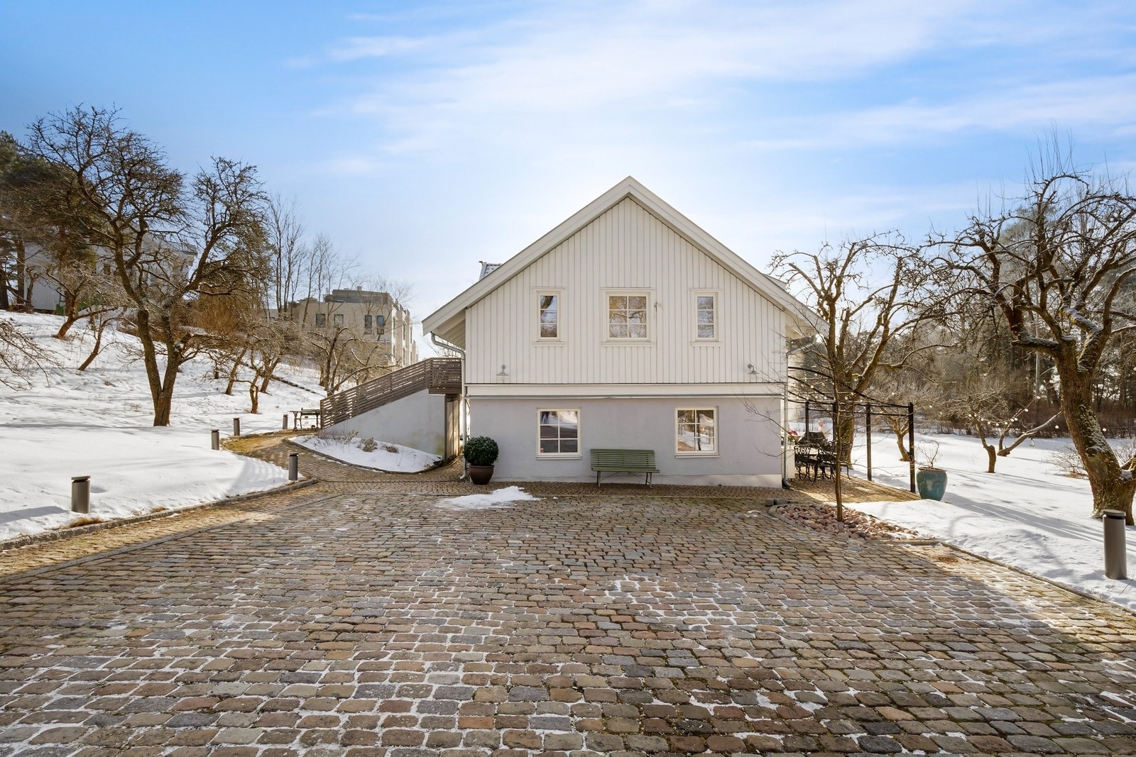 Stor gårdsplass med plass til flere biler. Det er montert ladestolpe for el-bil Galleribilde