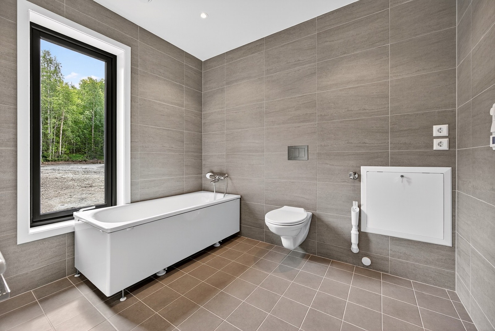 Toalettene monteres på vegg. I tillegg får hvert bad dusjhjørne med innfellbare dusjvegger, og rommene får selvfølgelig også gulvvarme og downlights.Badekar er ikke en del av standard leveransen. Bilder er ikke av selve boligen, kun ment som illustrasjon Galleribilde