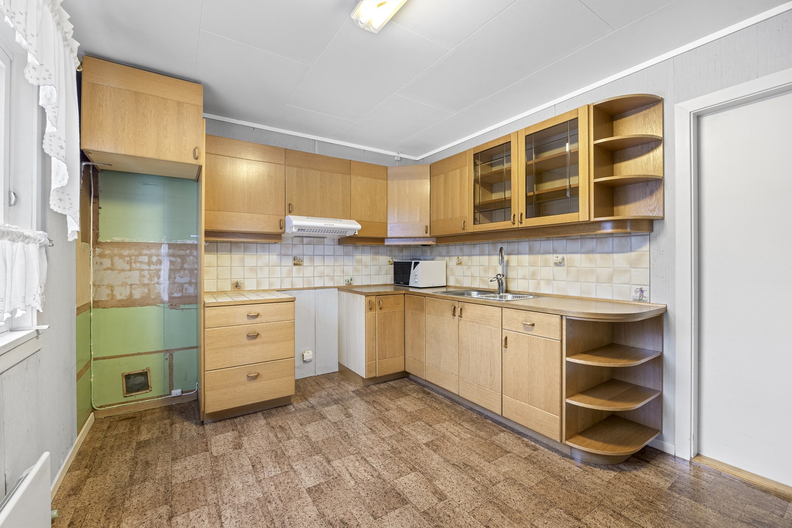 Rommet har godt med skapplass og opplegg for komfyr med avtrekksvifte. Galleribilde