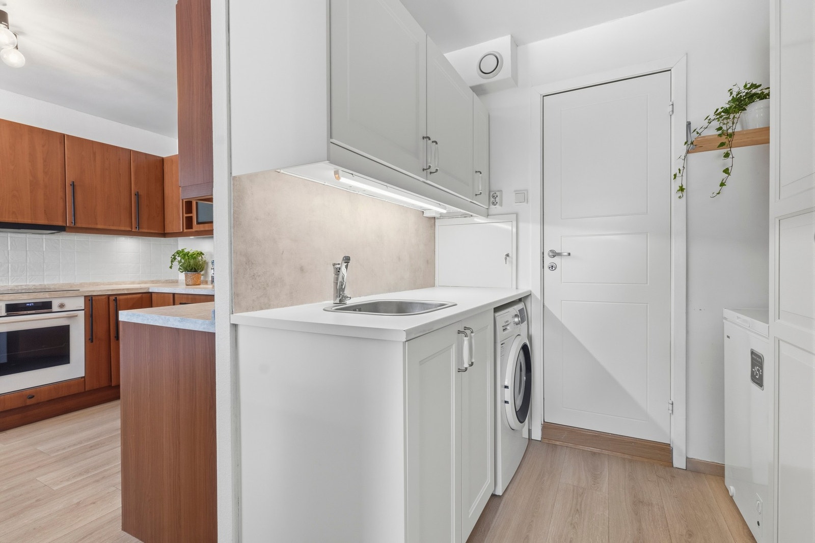 Rett ved kjøkkenet finner du et grovkjøkken med god skapplass, vask og opplegg til vaskemaskin Galleribilde