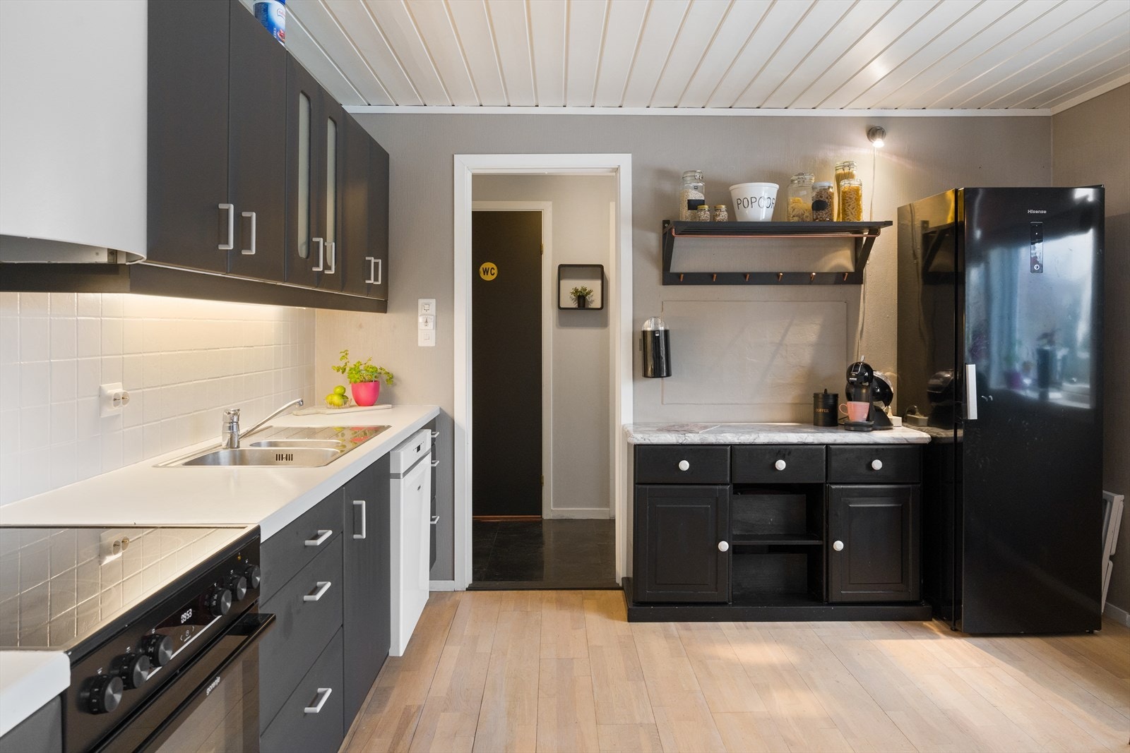 Kjøkkenet har godt med skap- og benkeplass og inneholder innredning med glatte fronter og laminat benkeplate Galleribilde