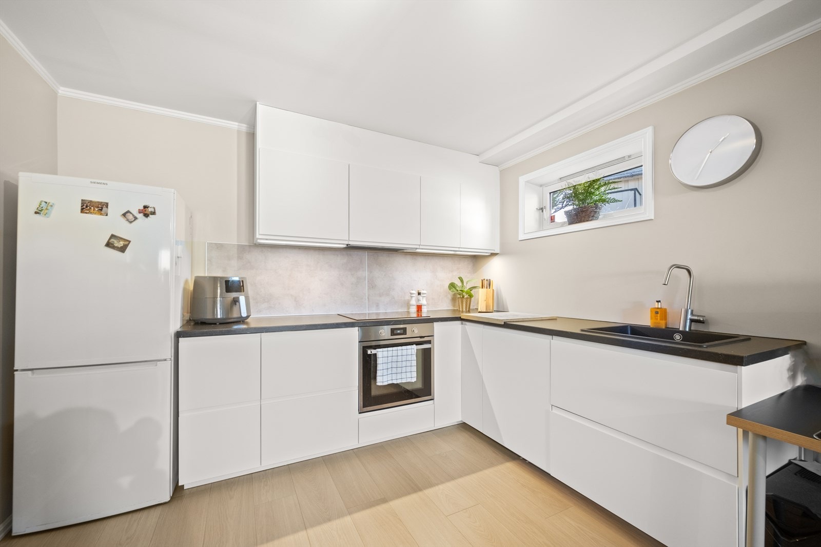 Hybel: Kjøkkeninnredning med glatte fronter og laminat benkeplate. Nedfelt vask. Integrert platetopp, stekeovn og oppvaskmaskin. Galleribilde