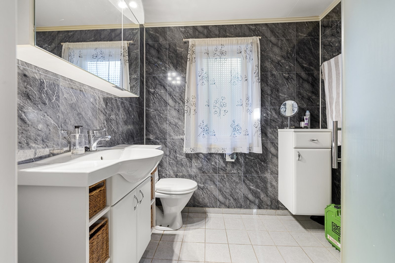 Badet i første etasje har flislagte overflater, servantinnredning og toalett. Galleribilde