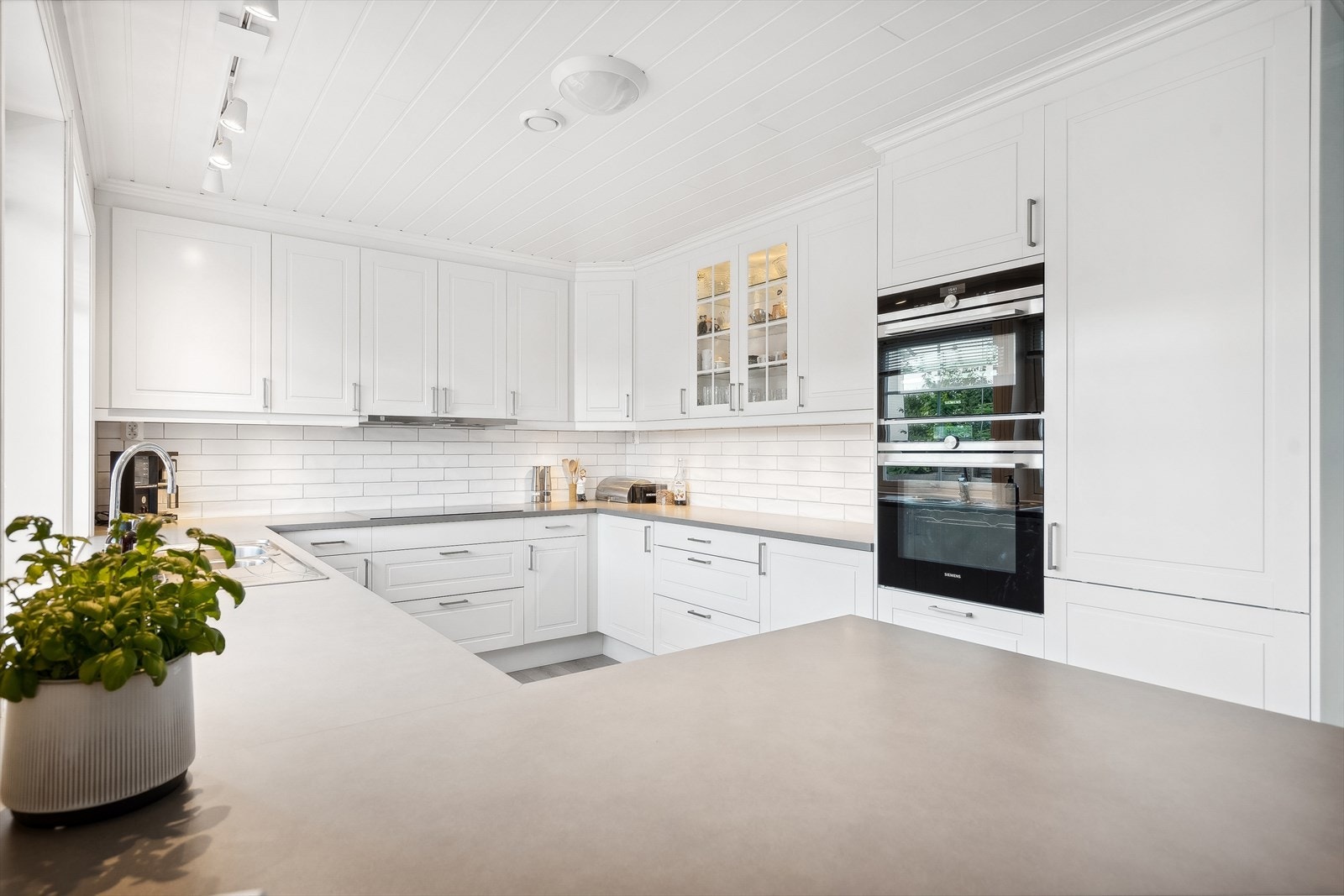 Fliser mellom benk og overskap gir et praktisk og tidløst uttrykk. Galleribilde