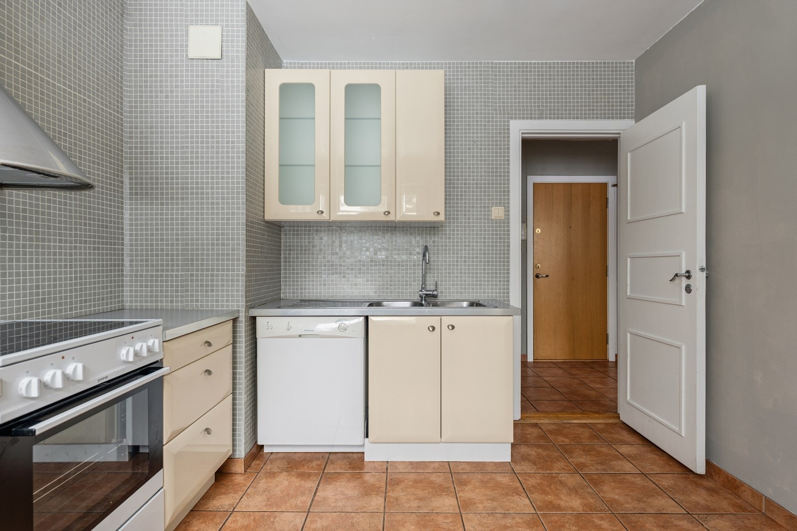 Profilert lakkert/høyglanset kjøkkeninnredning med laminat benkeplate, frittstående komfyr og oppvaskmaskin samt heldekkende stålkum med avrenningsbelag.
avrenningsbeslag. Galleribilde