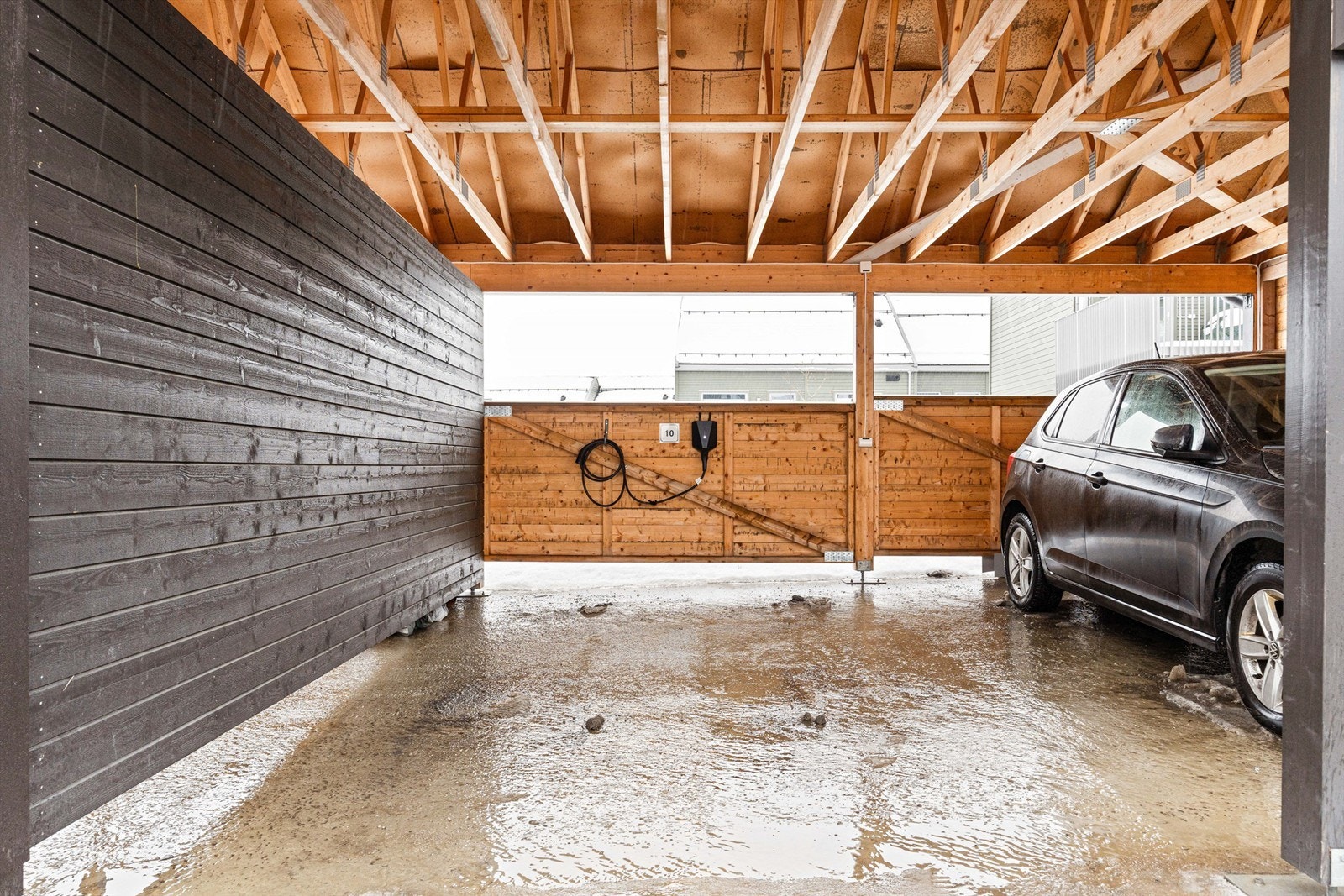Carport med ladepunkt. Ladeboksen leies i dag av sameiet. Galleribilde