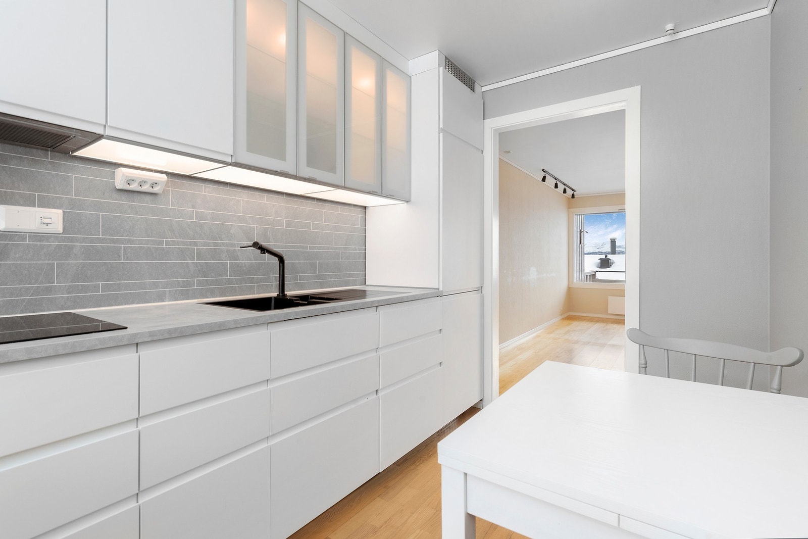 Delikat kjøkkeninnredning med glatte fronter og laminat benkeplate Galleribilde