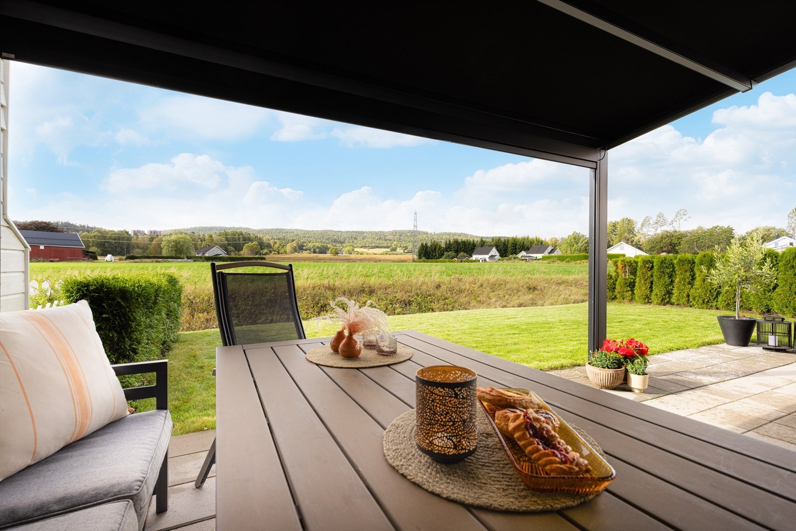 Terrassen ligger i direkte tilknytning til hagedel som disponeres av denne boenheten. Hagedelen er pent opparbeidet med plen og fint innrammet med tujahekk, mot naboer. Pergola på denne terrassen kan medfølge etter egen avtale. Galleribilde