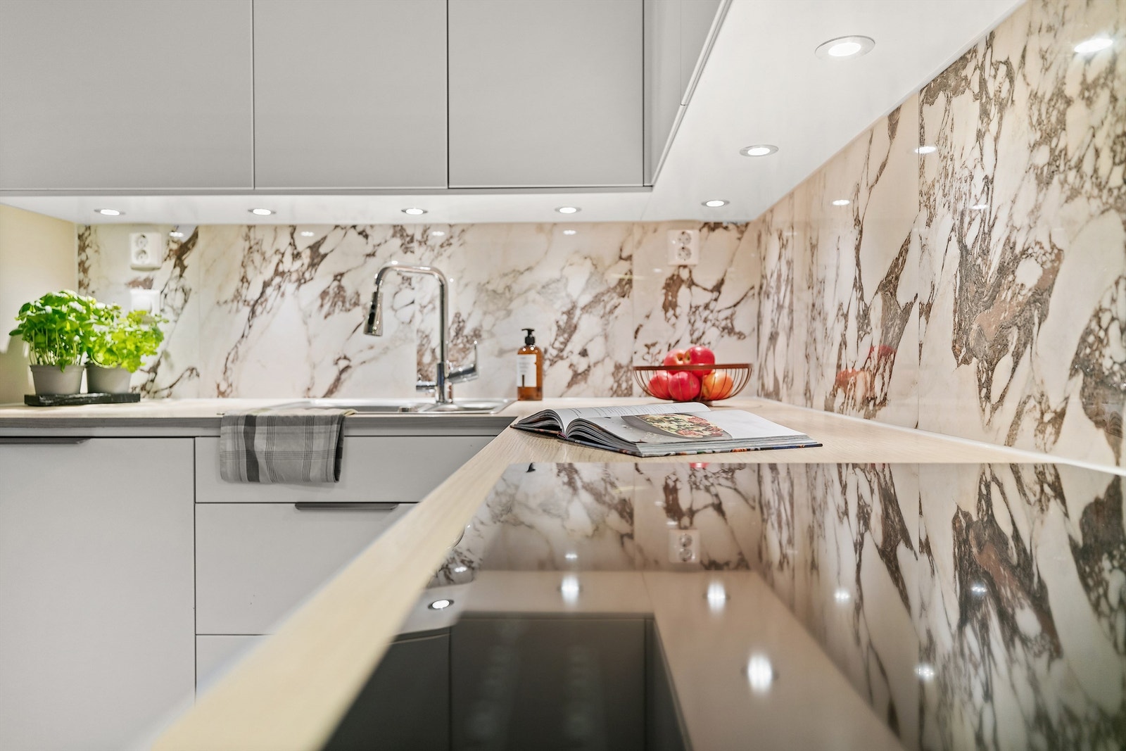 Benkeskapsbelysning og stikkontakter over kjøkkenbenk. Galleribilde