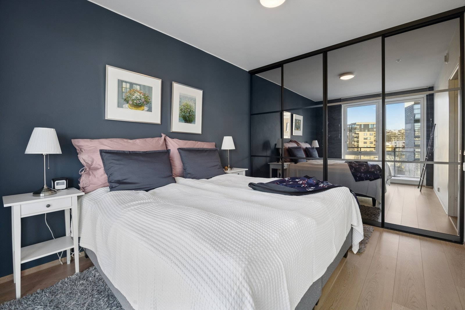 En stor skyvedørsgarderobe med speilfronter gir rikelig med oppbevaringsplass. Galleribilde