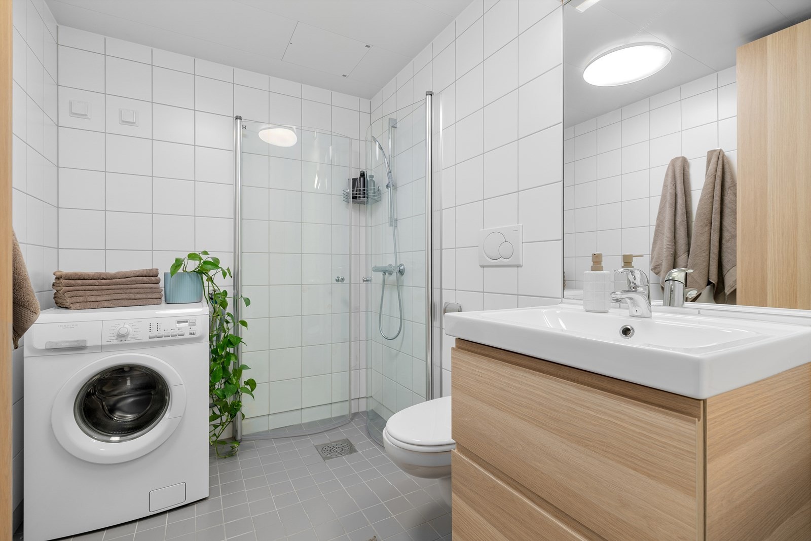 Flislagt bad med termostatstyrte varmekabler i gulvet for ekstra komfort. Innredning på badet er fra 2018. Felles mekanisk avtrekksventilasjon sikrer et godt inneklima på badet. Galleribilde