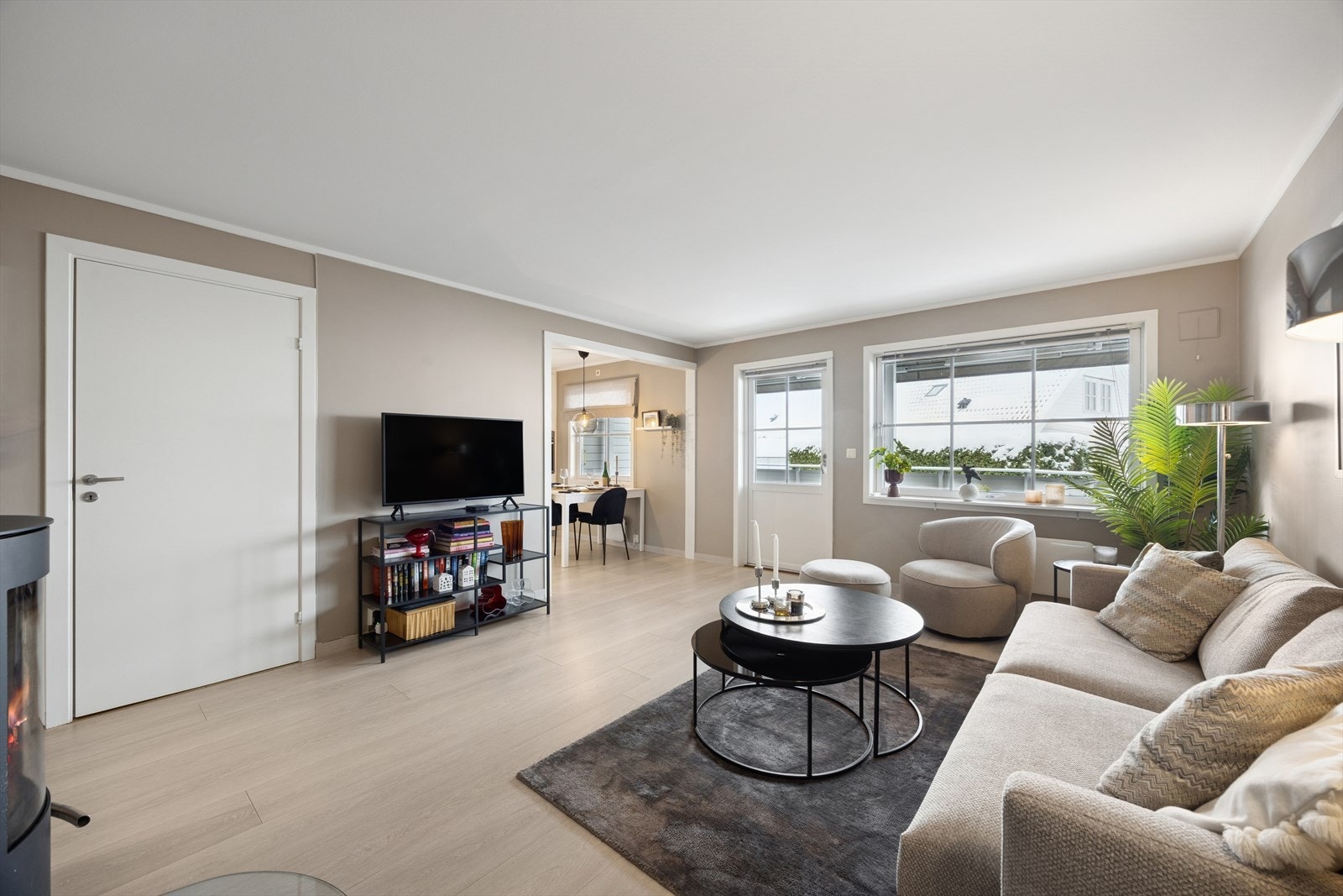 Velkommen inn i en lys og romslig leilighet med åpen løsning mellom stue og kjøkken - et sosialt og innbydende oppholdsrom Galleribilde