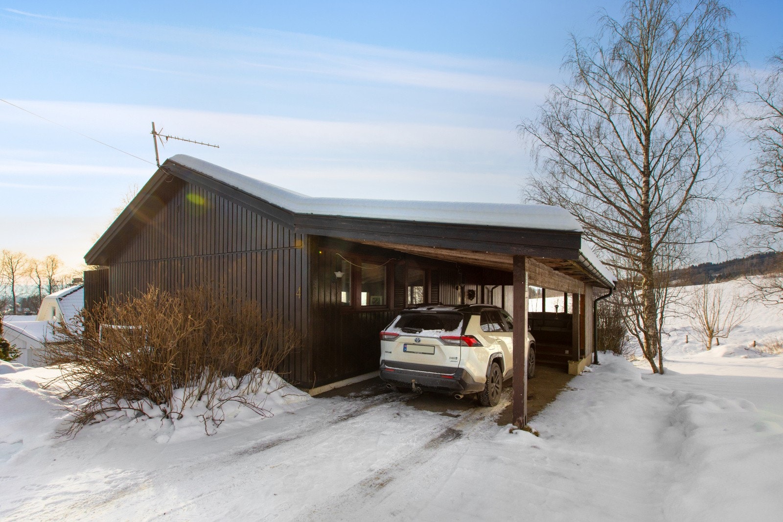 Første etasje er det parkering i carport tilknyttet inngangspartiet. I tillegg er det plass til flere biler på gårdsplassen. Galleribilde