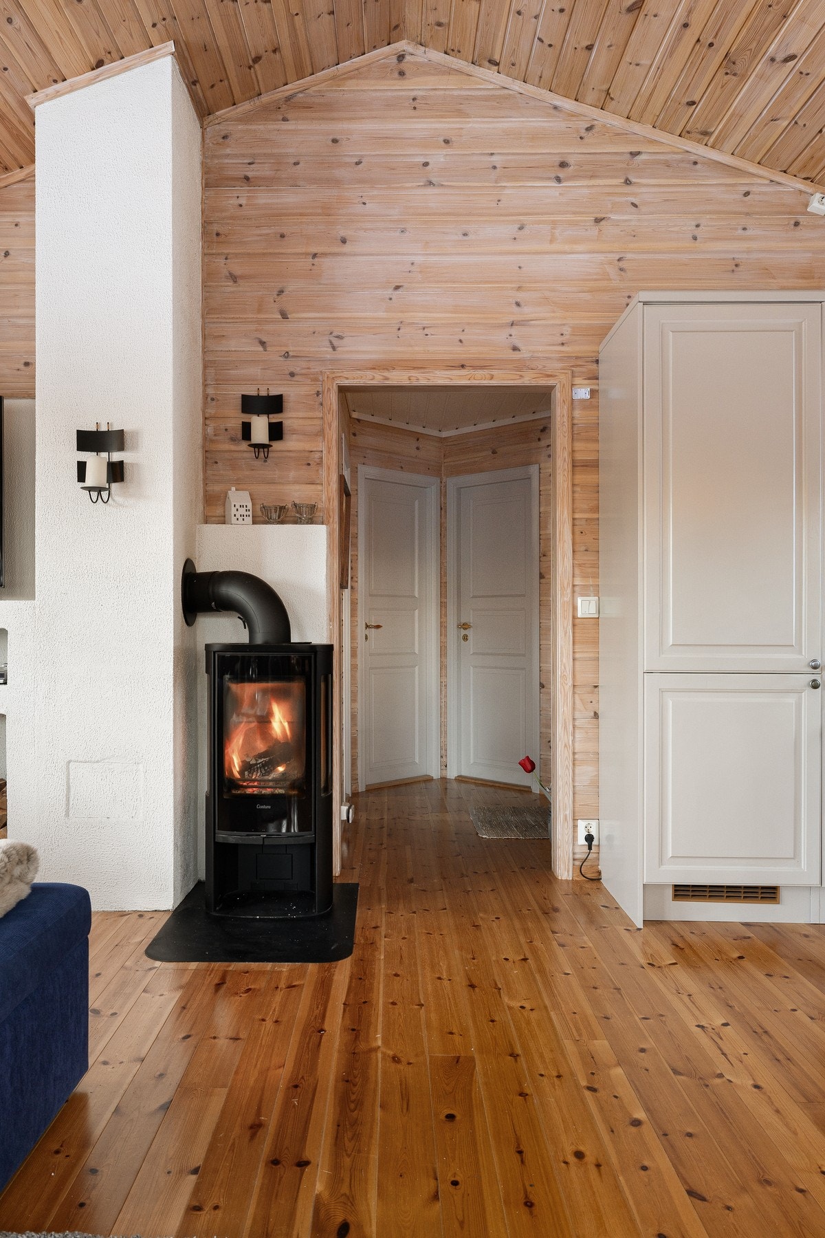 Lukket peisovn er plassert sentralt i rommet og bidrar både med effektiv oppvarming og en lun stemning på kjølige dager. Galleribilde