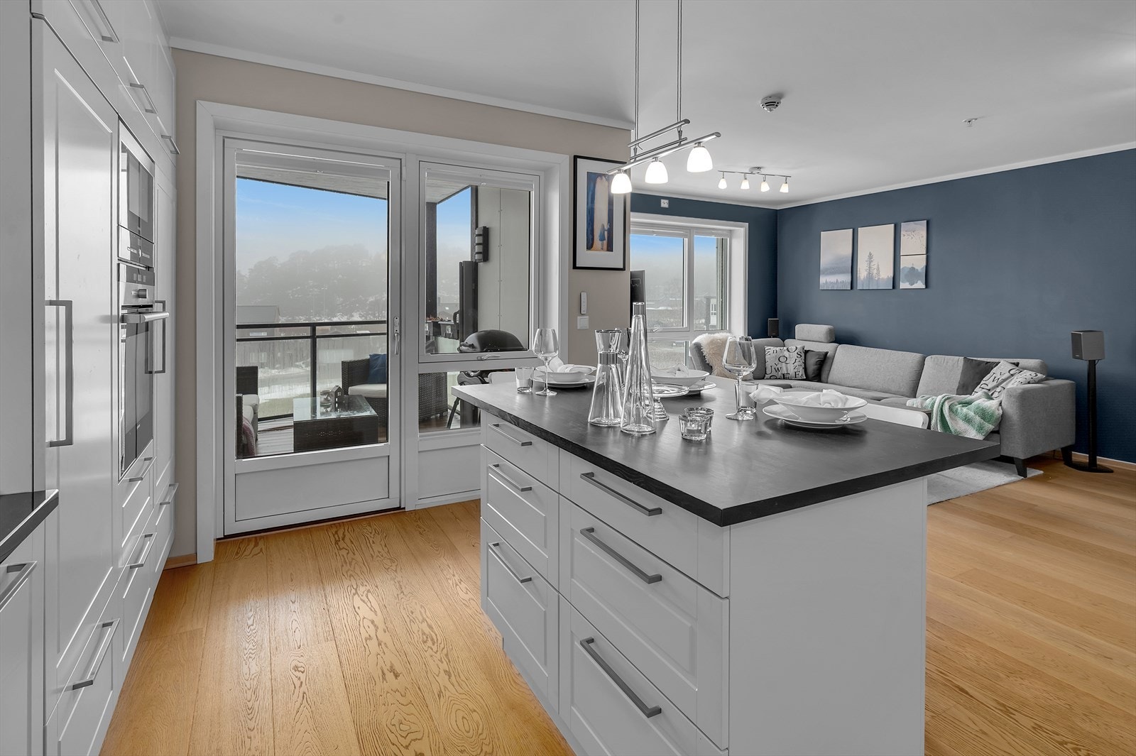 Den åpne løsningen mot kjøkkenet gir et luftig og funksjonelt oppholdsrom som passer både til hverdagsbruk og sosiale sammenkomster. Galleribilde