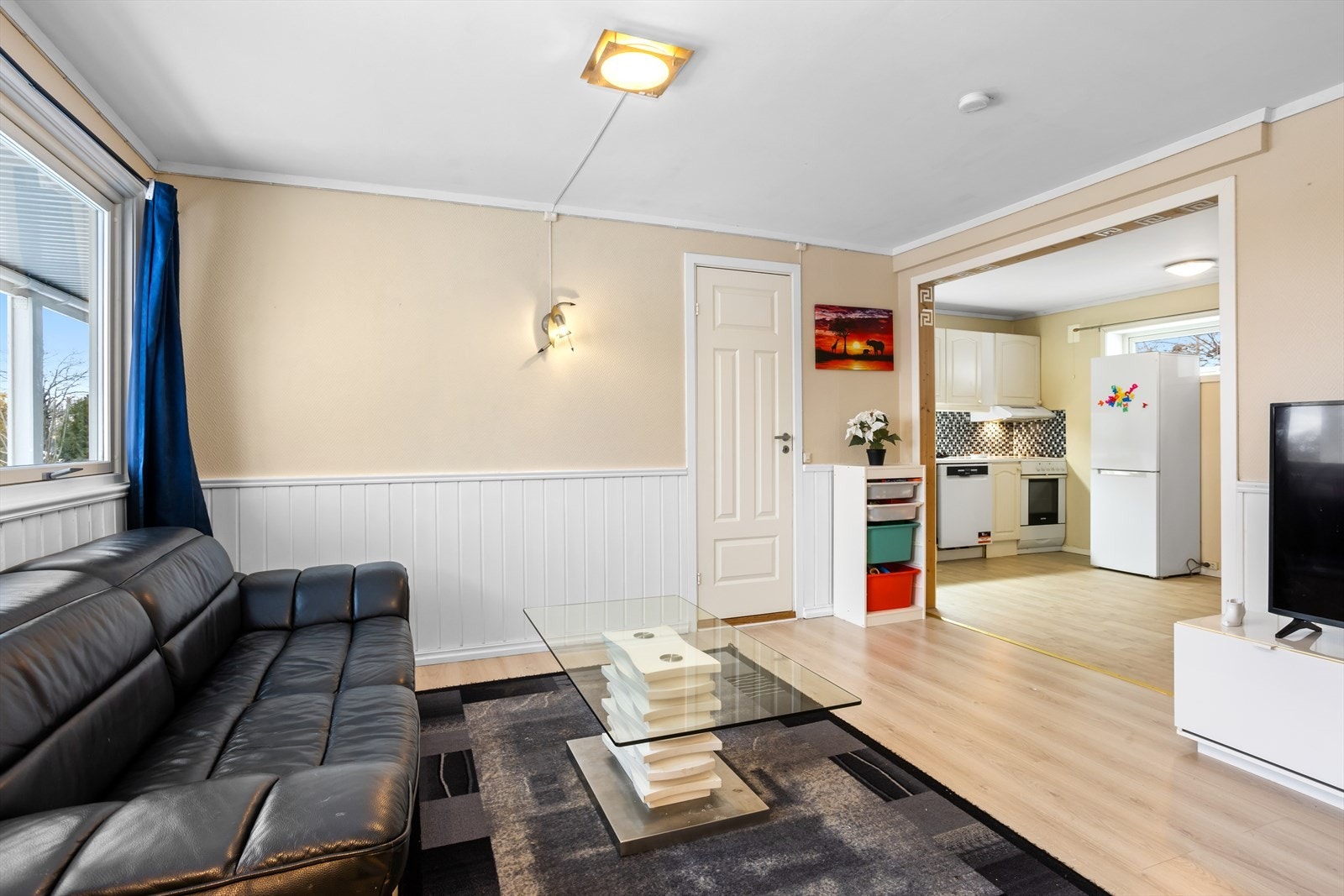 Stuen i underetasjen ligger i en delvis åpen løsning mot kjøkkenet, noe som gir en praktisk og fin sammenheng mellom oppholdsrommene Galleribilde