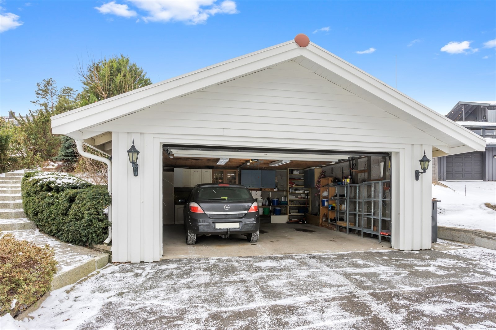 Dobbelgarasjen har et areal på ca. 35 m² og er dimensjonert for to mindre biler. I tillegg er det praktisk plass til noe lagring. Galleribilde