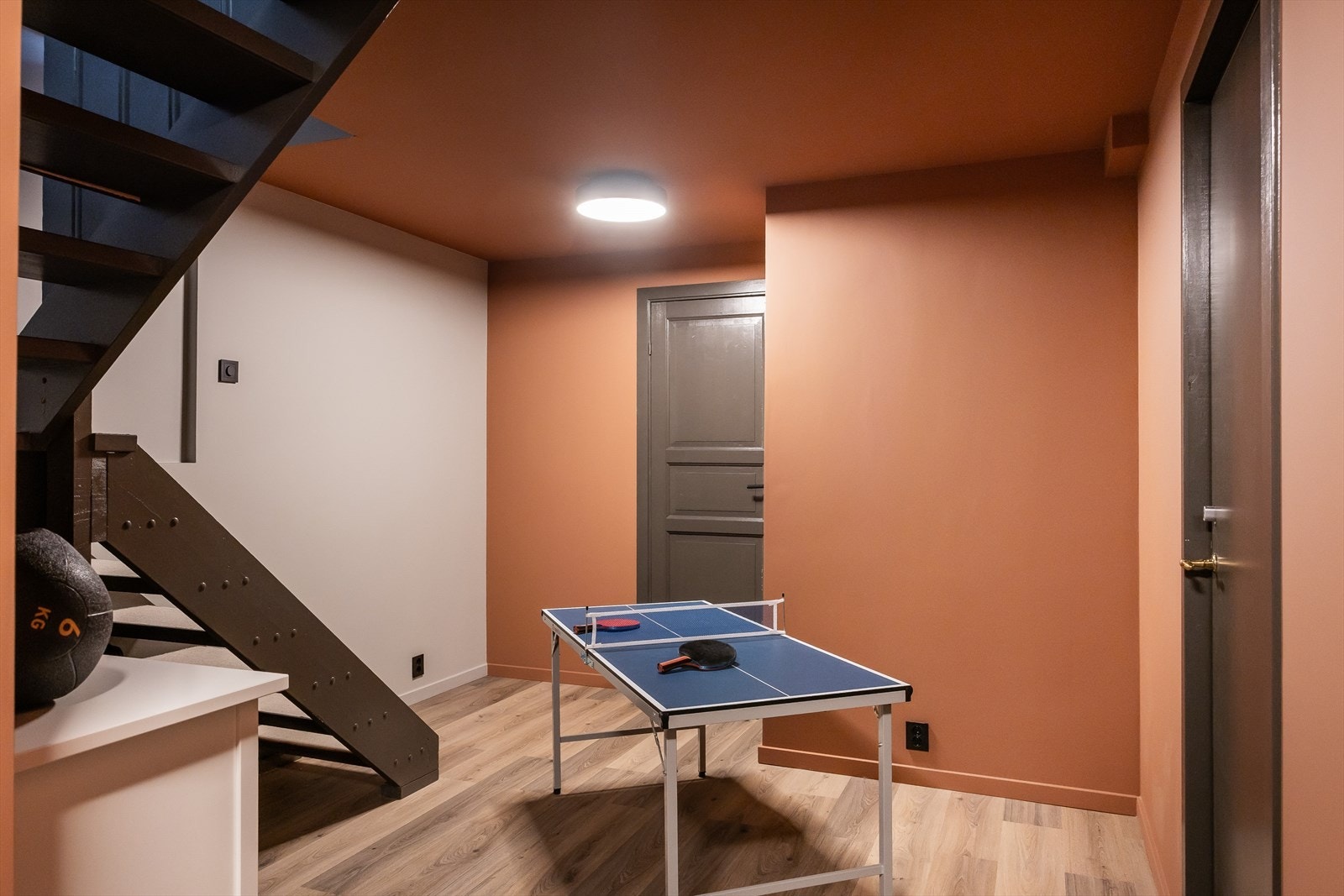 Veggene i gangen i kjeller er farget i terracotta. Galleribilde