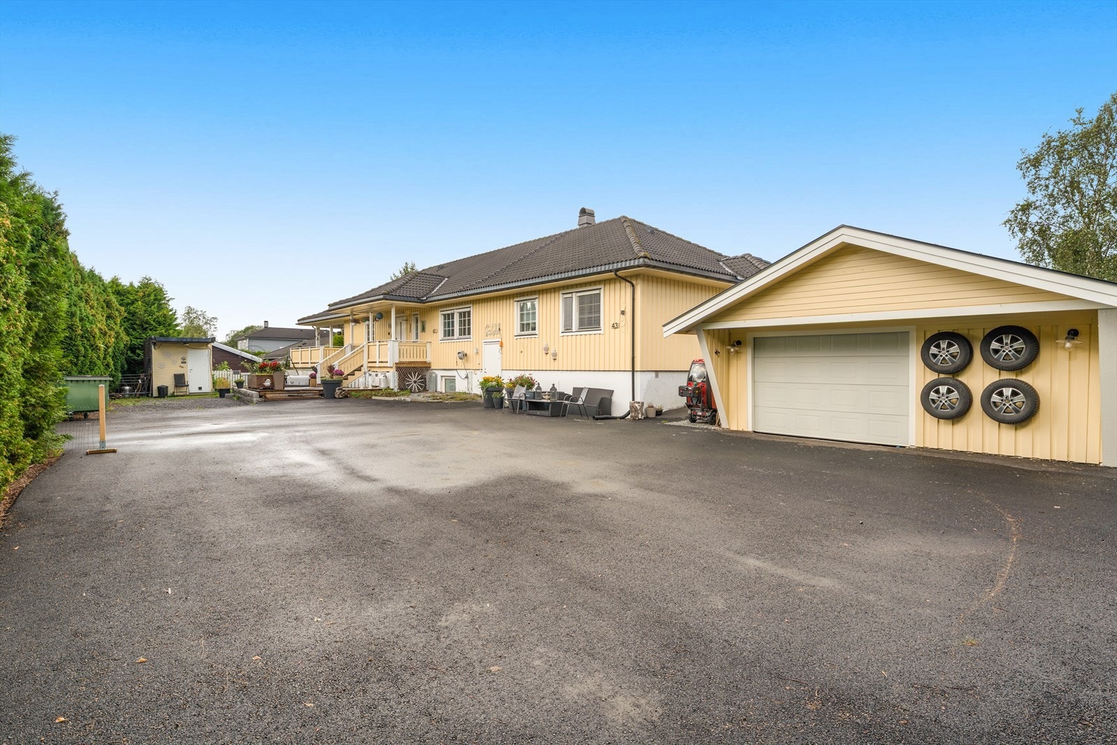 Stor asfaltert innkjørsel og garasje. Galleribilde