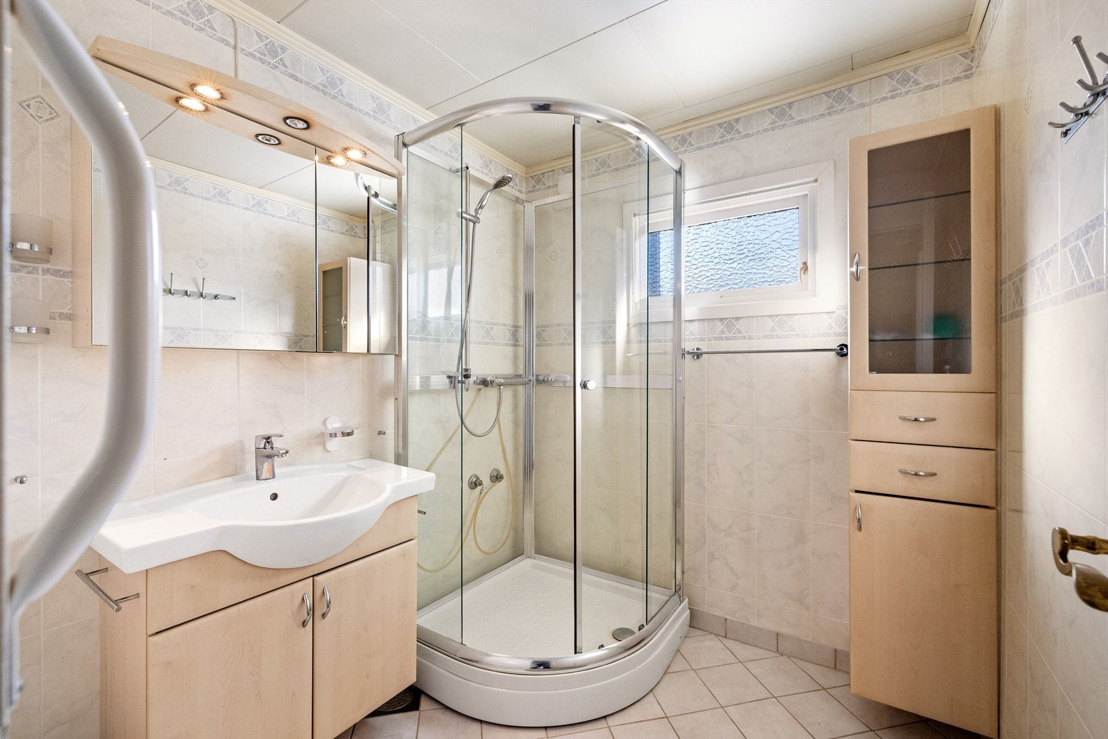 Badet i første etasje har flislagt gulv med gulvvarme og dusjkabinett. Galleribilde