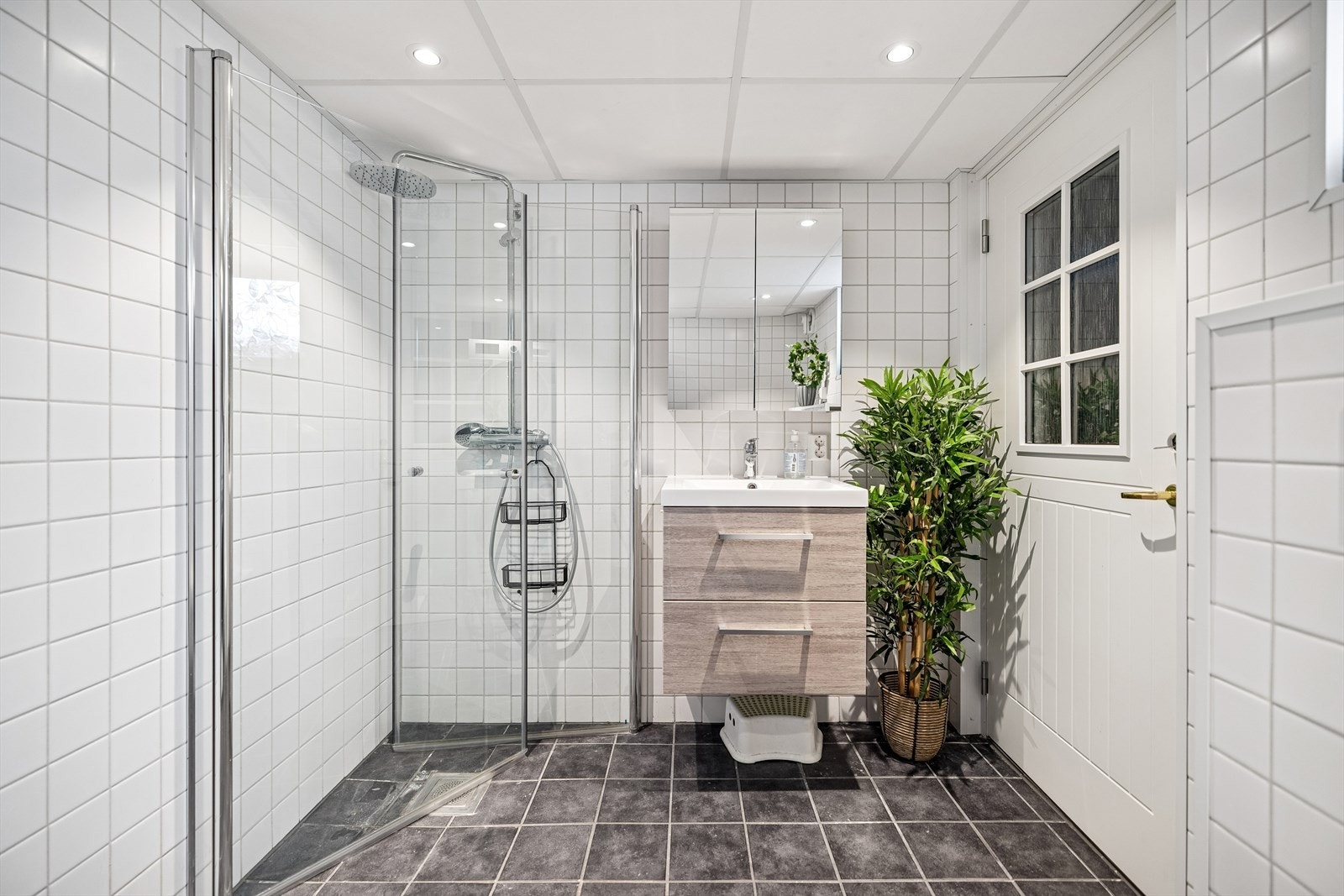 Flislagt bad med dusjløsning og tidsriktige overflater. Galleribilde