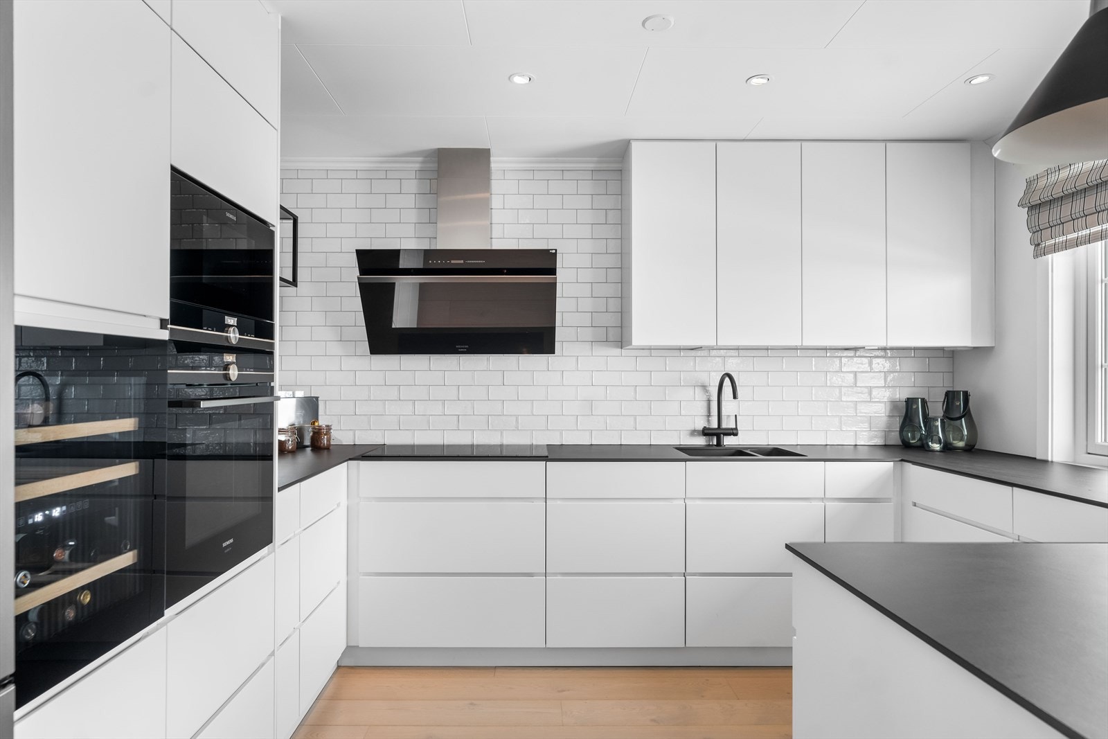 Videre er det fliser mellom overskap og benkeplate, samt godt med belysning. Galleribilde