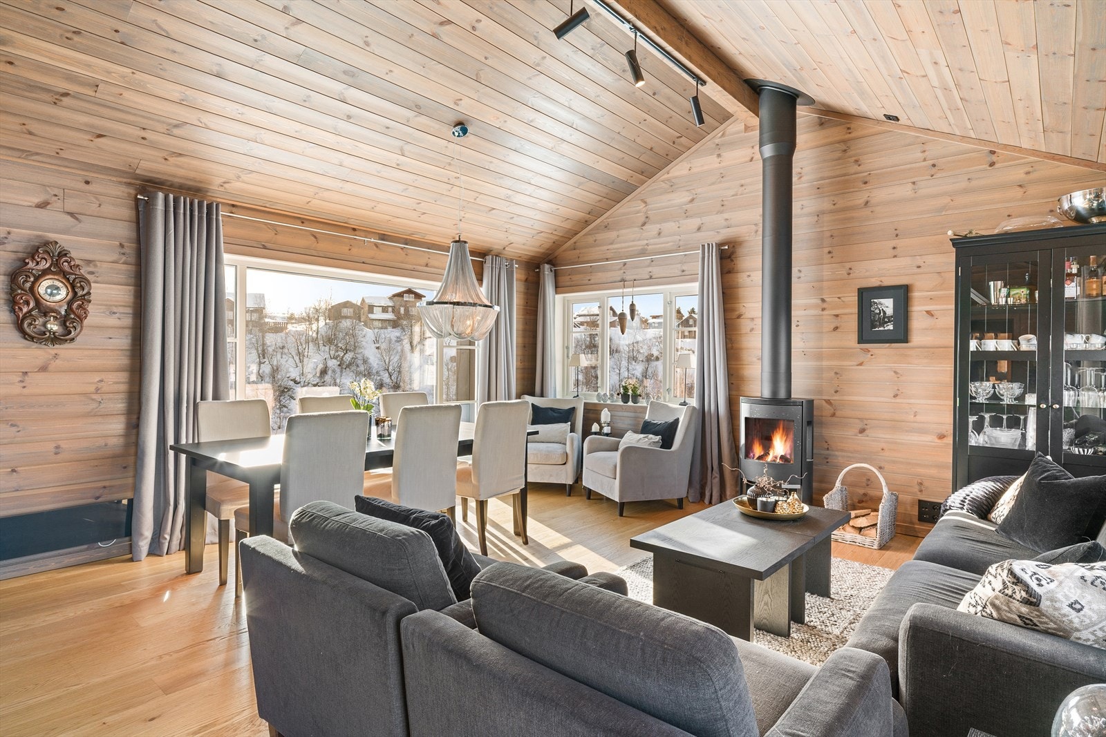 Mønt himling og velplassert vedovn | Samme farge på panel på vegger, i tak og listverk skaper den lune hyttestemningen | Dette er gjennomgående i hele hytten Galleribilde