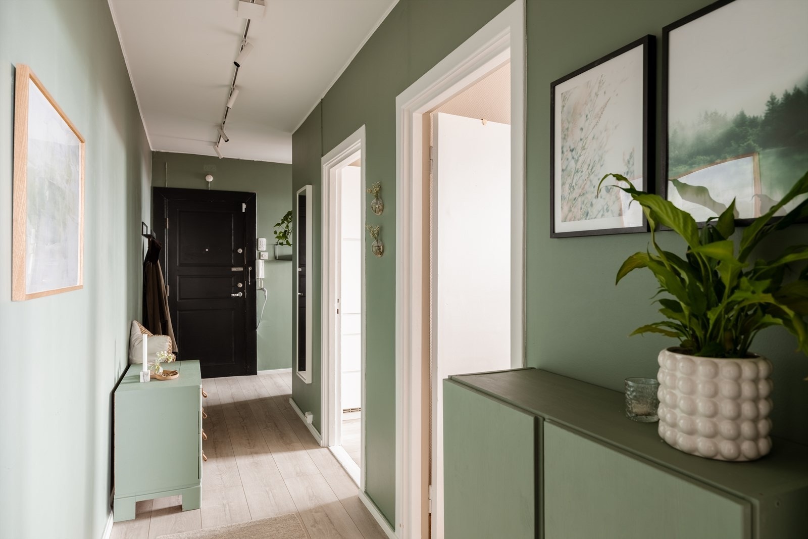 Praktiske oppbevaringsløsninger og speil som bidrar til en god romfølelse Galleribilde