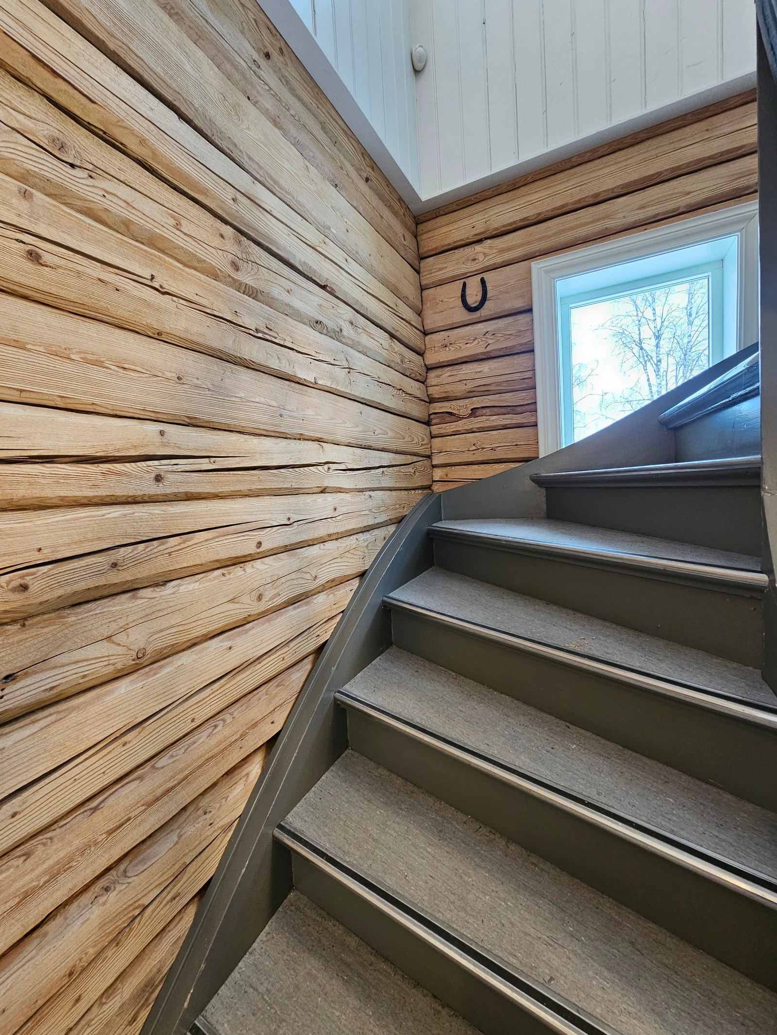 Originalt tømmer i trappeoppgang; tømmeret er bevart etter brannen i 2011. Galleribilde