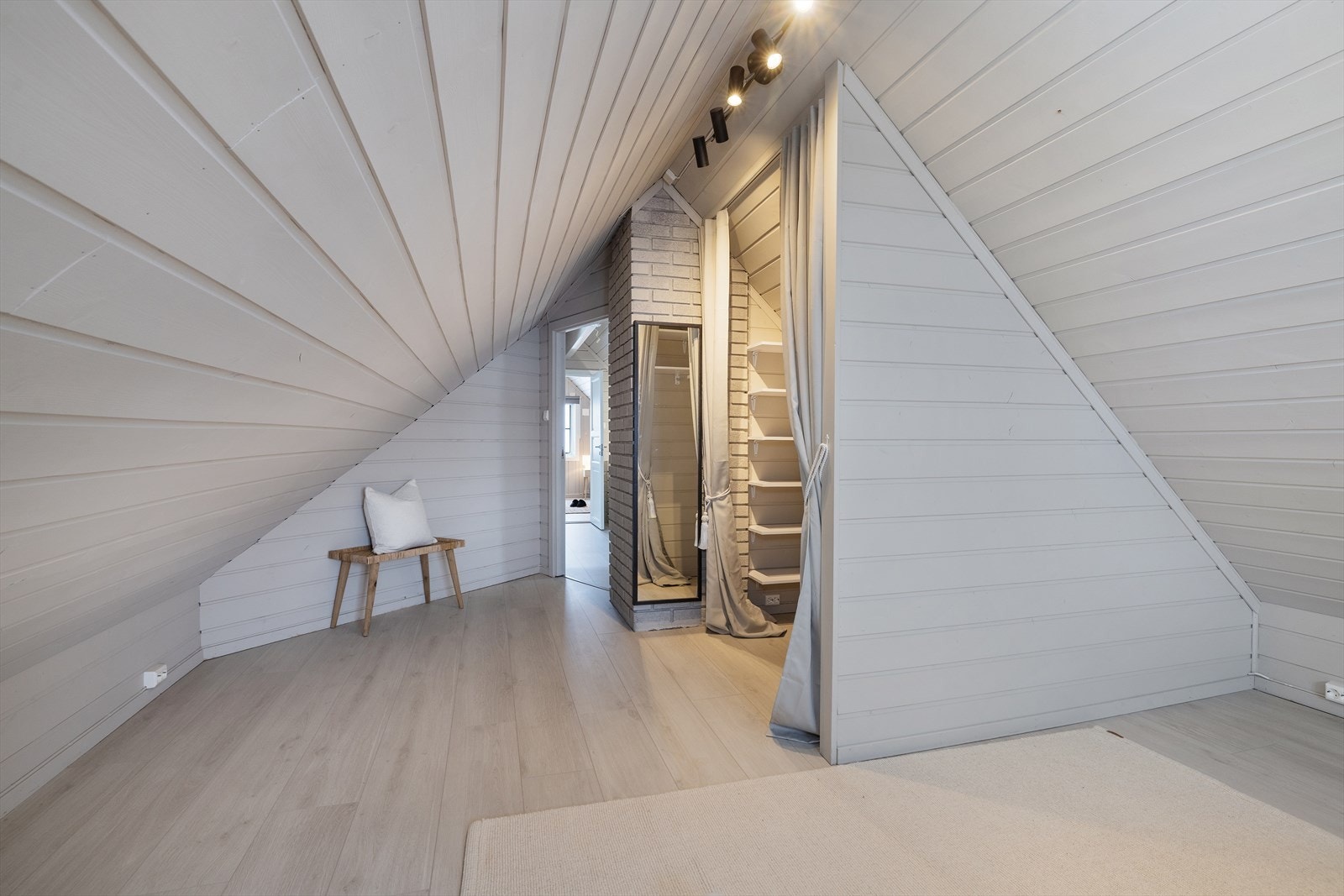 Et av soverommene på loftet har en smart, plassbygd garderobeløsning. Galleribilde