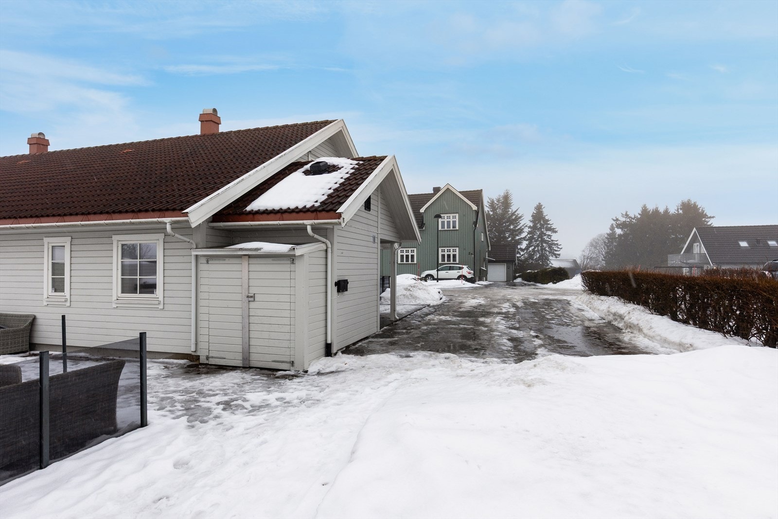 Romslig gårdsplass med liten hageflekk i bakkant. Galleribilde