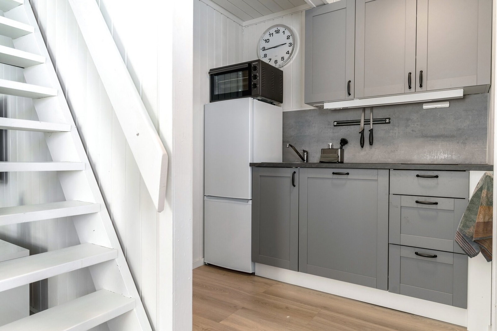 Enkelt kjøkken utstyrt med koketopp, oppvaskmaskin, kjøl/fryseskap, hybelkomfyr og oppvaskkum. Galleribilde