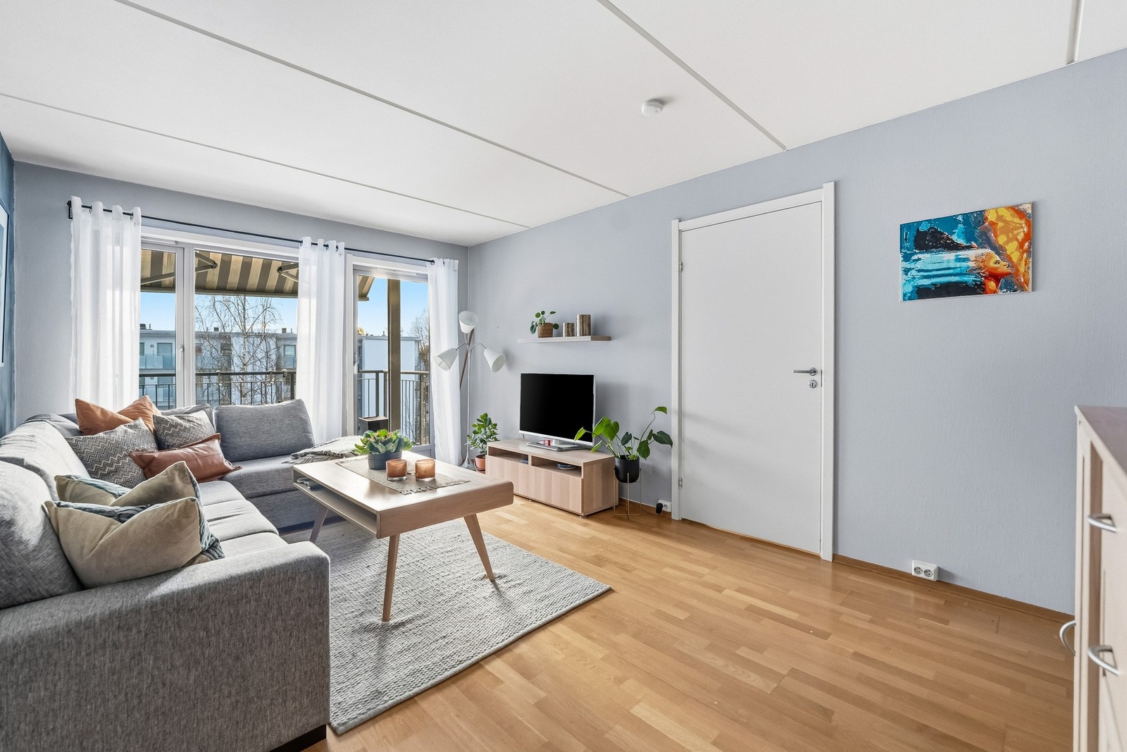 Romslig stue med god plass til sofagruppe og møblering, og store vindusflater som slipper inn mye lys. Galleribilde