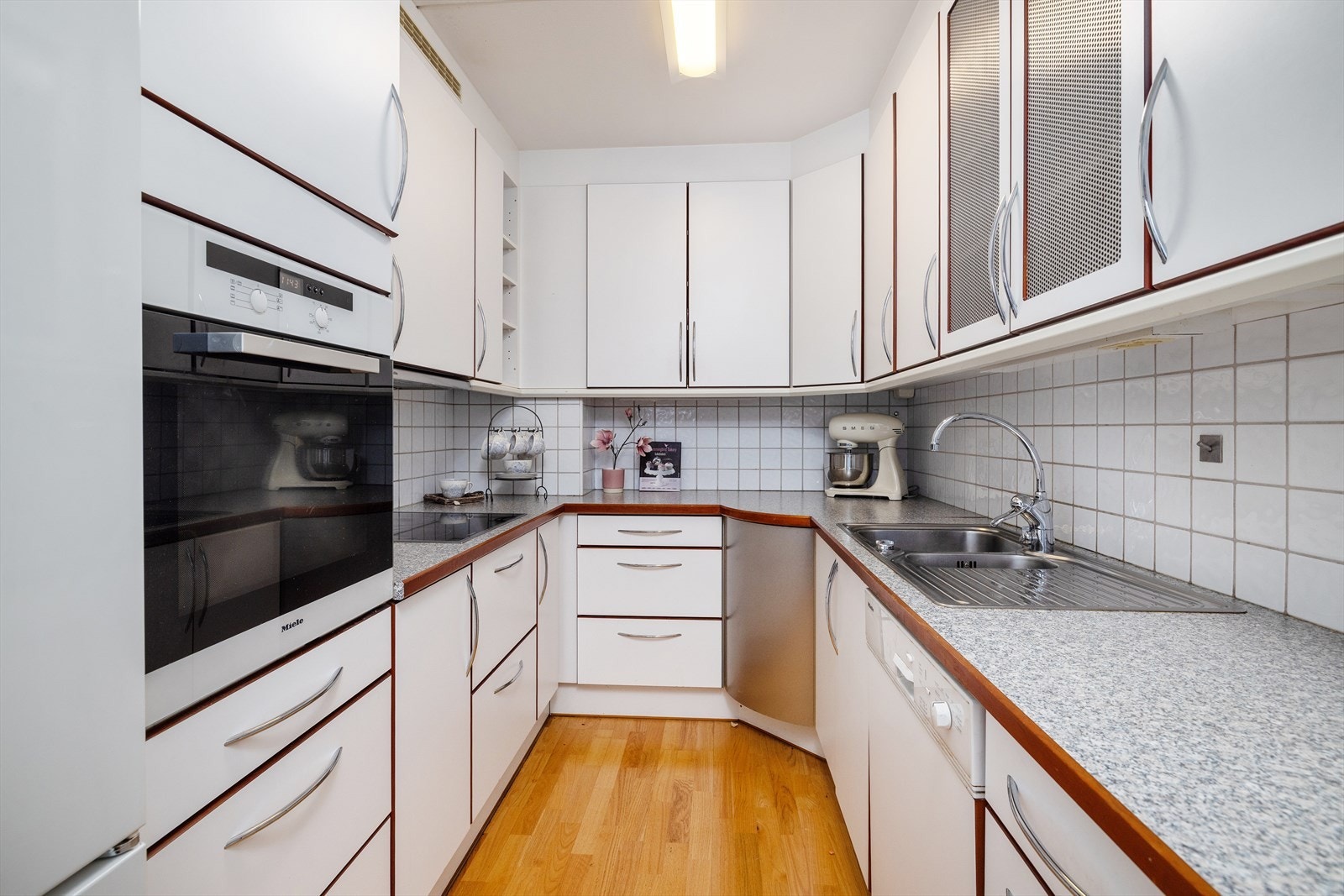 Kjøkken med innredning langs tre sider. Innredning fra JKE Design med mye skap- og skuffeplass. Galleribilde