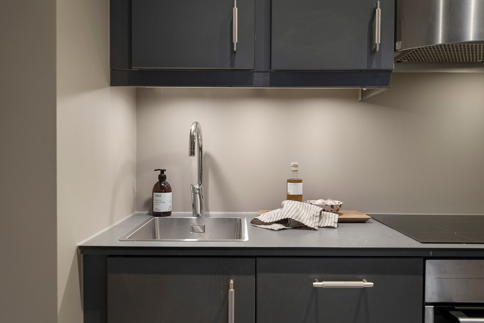 Kjøkkenet er innredet med integrerte hvitevarer som komfyr, induksjon platetopp, oppvaskmaskin og kjøl/frys. Galleribilde