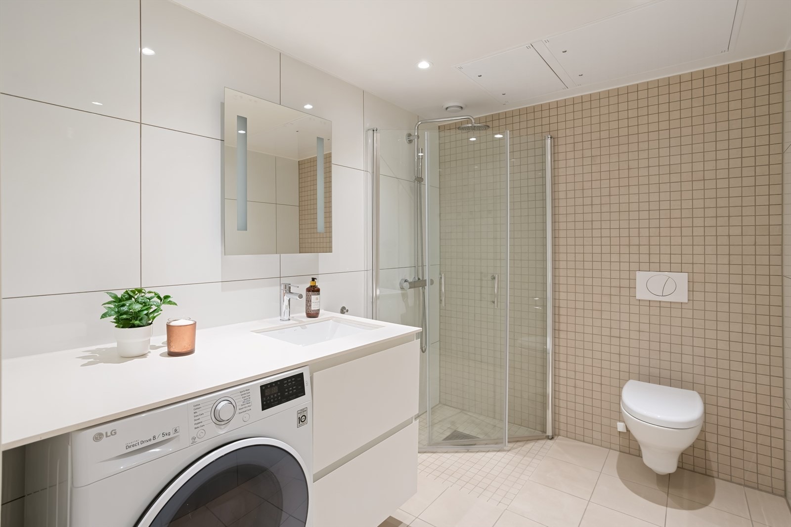 Badet er av god størrelse og har vegghengt wc med skjult sisterne og dusj med innfellbare glassdører Galleribilde