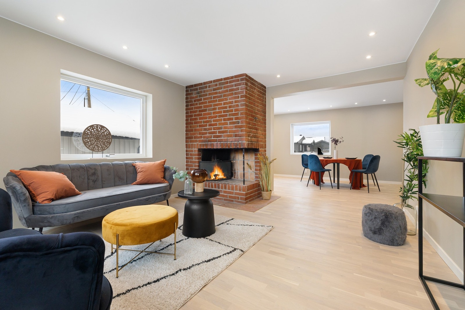 Boligen byr på et svært luftig allrom med stue, peis, og spisestue, samt utgang til hagen. Galleribilde