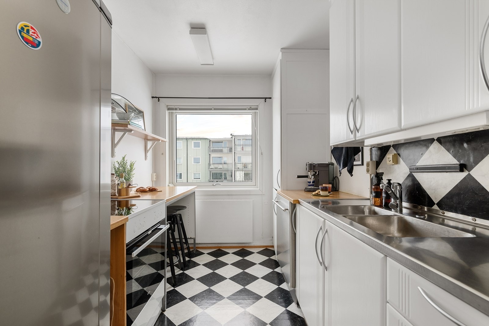 Praktisk kjøkken med profilerte fronter, laminert benkeplate og plass for en liten spisegruppe. Galleribilde