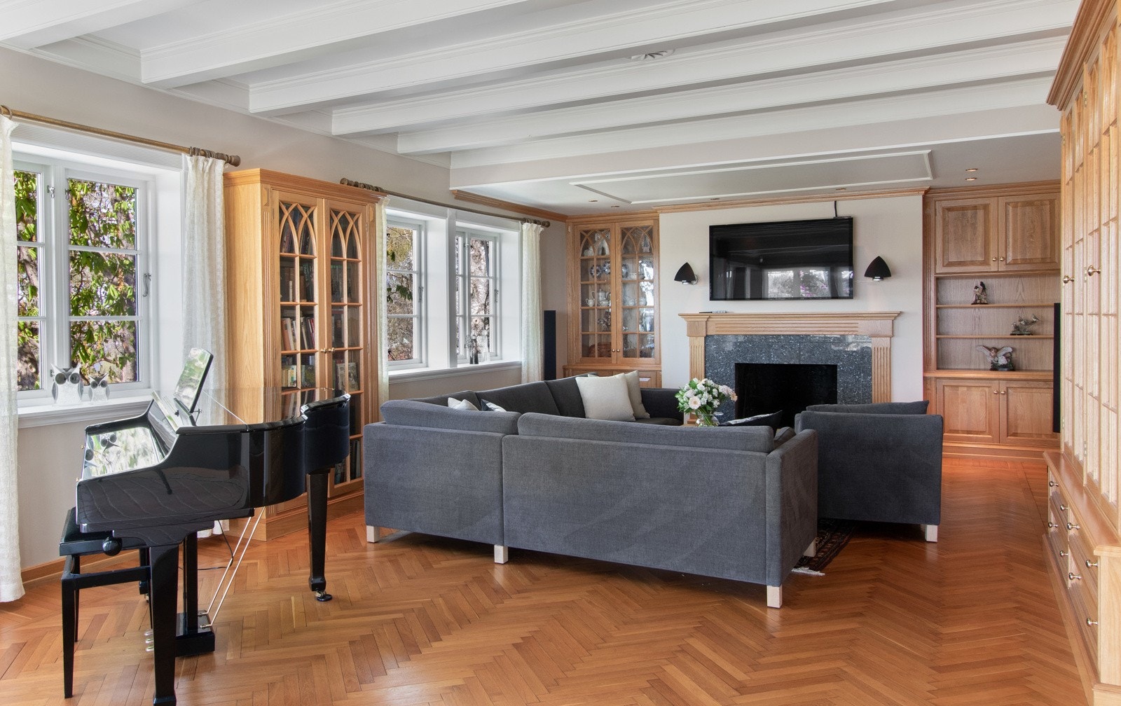 Stuen har to plassbygde vitrineskap fra Gjeving Trevarefabrikk, i tillegg til hyller og skap på hver side av peisen. Galleribilde