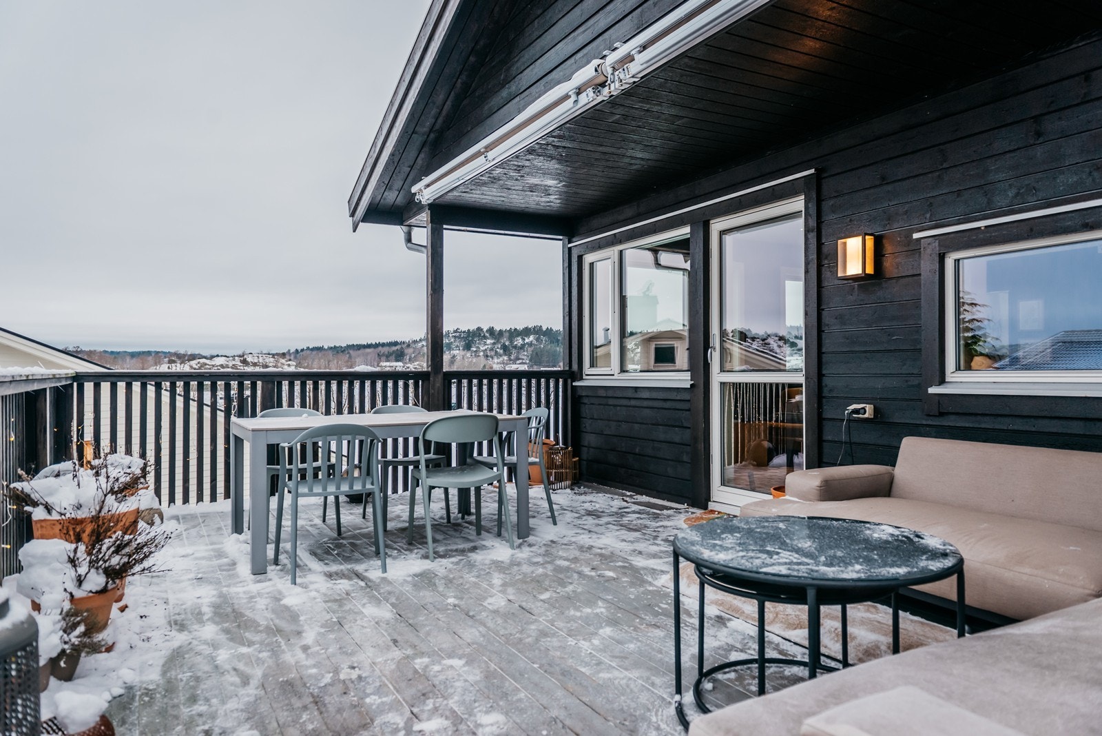 Verandaen er stor og romslig, her er det plass til både sofa og spisebord Galleribilde