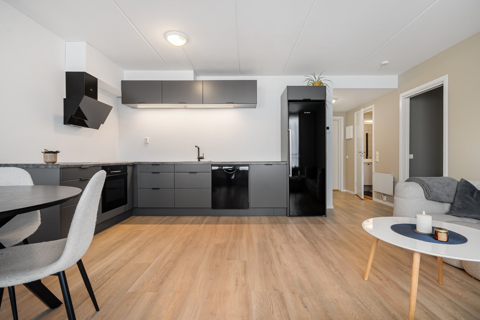 Åpen og moderne stue/kjøkkenløsning med stilrent kjøkken, gode lysforhold og god plass til både spisegruppe og sofakrok. Galleribilde