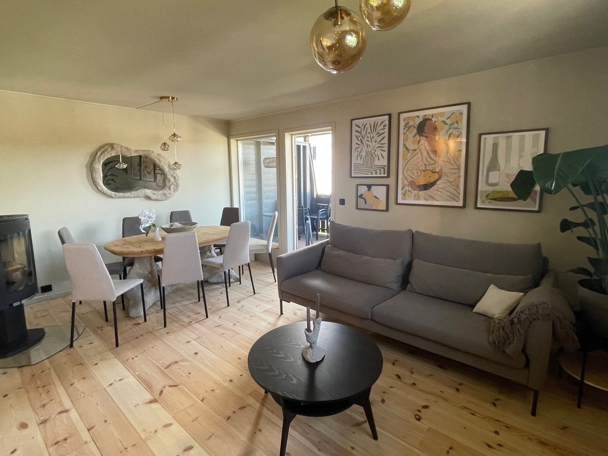 Lys og trivelig stue med peis, samt god plass til både sofakrok og spisebord. Galleribilde